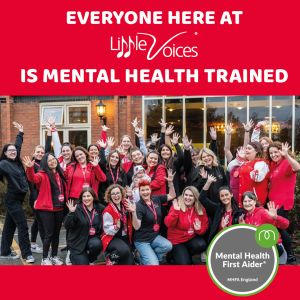 Group of Little Voices franchisees punching the air, with the mental health first aid training logo in the foreground