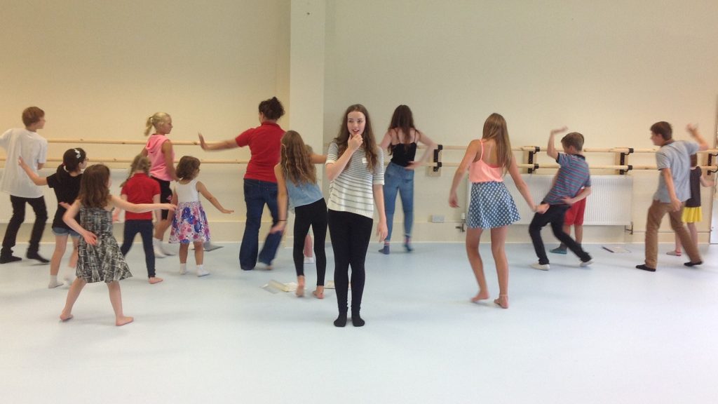 Group of children & young people rehearsing at one of Little Voices holiday workshops