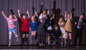 Group of children on stage during one of Little Voices theatre weeks